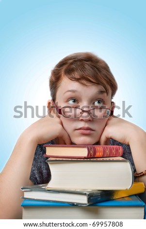 Photo of young girl studying with books