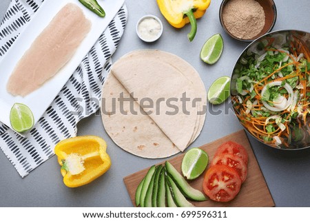 Ingredients for fish tacos on grey background