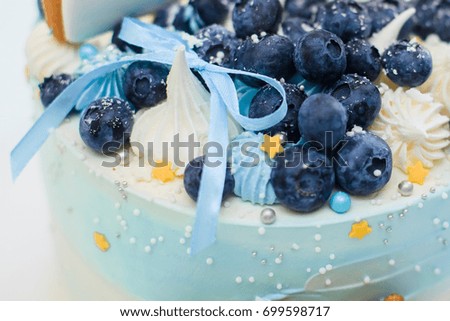 Cake in blue with blueberries and blue bow