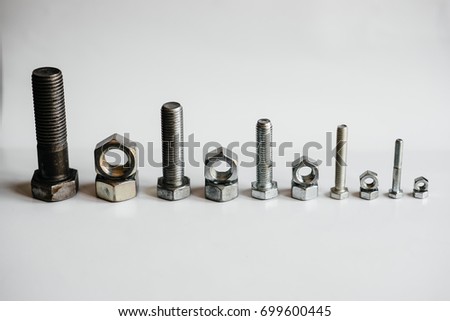 Nuts and bolts stand in decreasing order of size. Tool.