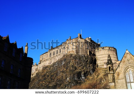 Edinburgh castle pictured from the Grassmarket against at bright blue sky on a sunny day in Scotland