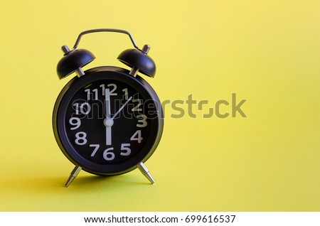 Alarm clock with six o'clock on yellow background in minimalistic retro pop art style with place for text. Wake up concept. Back to school. Copy space.