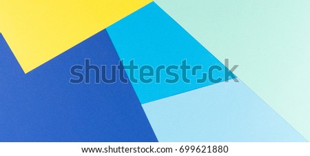 Color papers geometry flat lay composition background with yellow and blue tones