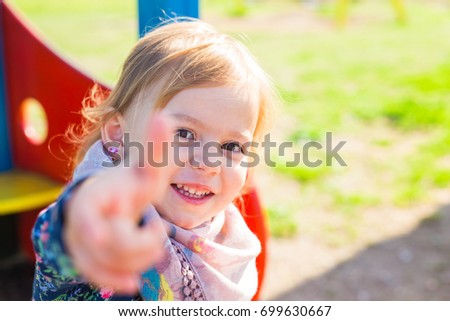 happy child girl showing thumbs up