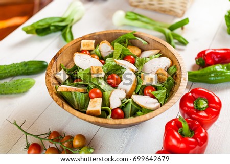 chicken salad bowl on kitchen table, balanced diet