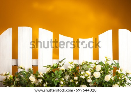 White fence decorated with flowers.