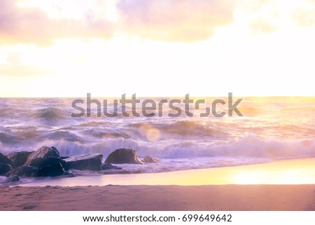 Splashing of wave against rock on the beach