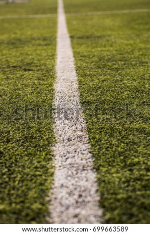 green grass pattern for football sport, Football field, soccer field, team sport texture. White stripe on it. Close up focus.