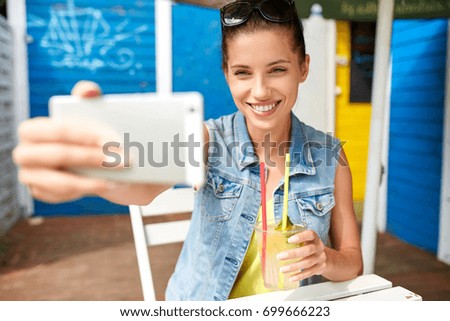 Young happy girl is taking a picture