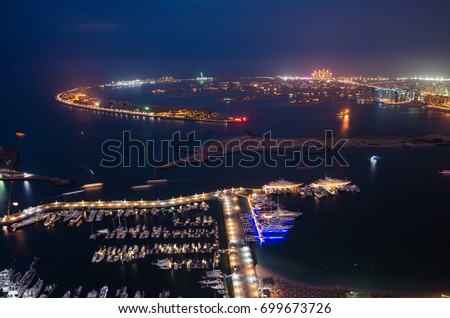 A breathtaking panoramic view of the Palm Jumeirah at night from a height, Dubai, United Arab Emirates Royalty-Free Stock Photo #699673726