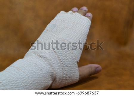 left hand wrapped in an elastic Bandage.