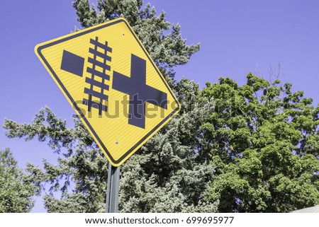 Railroad crossing sign that is diamond shaped
