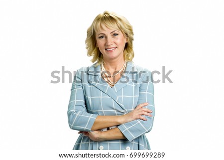 Elegant mature woman crossed arms. Smiling white-skin woman crossed arms standing on white background, front view.