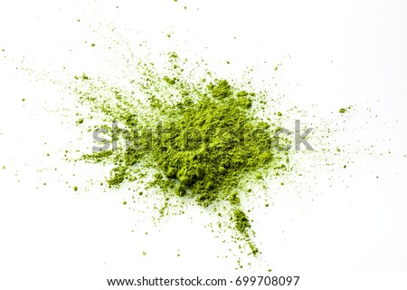 Matcha powder explosion on white background from above. Matcha is made of finely ground green tea powder. It's very common in japanese culture. Matcha is healthy due to it's high antioxydant count. Royalty-Free Stock Photo #699708097