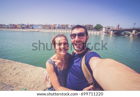 handsome happy couple take photo selfie in Seville, Spain, during a world trip tour
