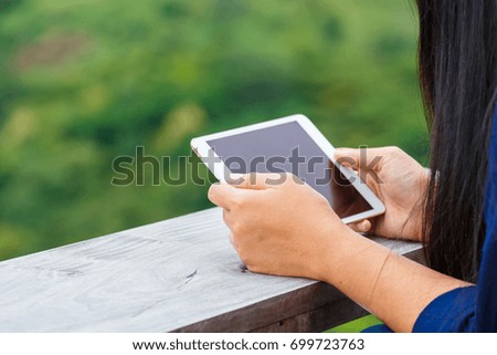 Closeup woman's hand use tablet by horizontal