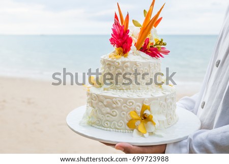 Beautiful cake setup for wedding ceremony on beach.