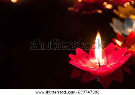 Light the lotus candle on water for pray buddha