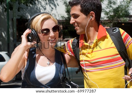 Portrait of a young couple cheerfully spending time in the street