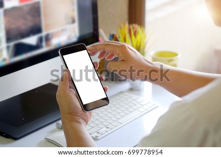 Man using smartphone on White office desk table. 