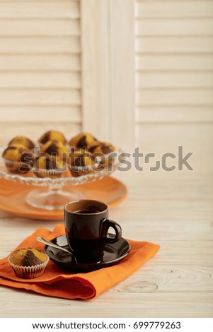 Coffee with muffins on a light wooden background. Selective focus.