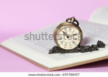 An open book with old watch, education concept
