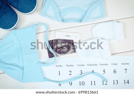 Vintage photo, Pregnancy test with positive result, ultrasound scan of baby, clothing for baby