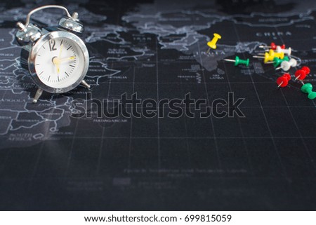clock is on the map with pins to pin in to the destination. on the map Time of Travel Planning Around the World, concept travel and relax , selective focus of clock.