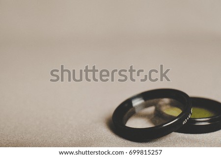 Two color optical filters for the camera on fabric background with copy space