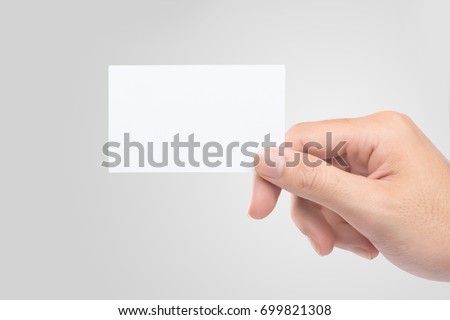 Male hand holding blank business card isolated