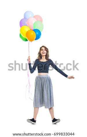 Surprised beautiful woman holding colorful balloons and having fun isolated on white background. Full length portrait