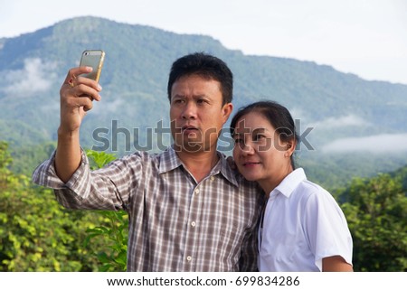 Asian family happy taking photo selfie view mountain morning 