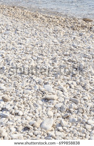 Beach with soft waves and small white stones, Blue sea in summer, Beach backgrounds