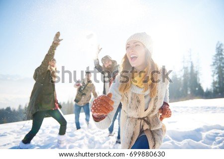 Woman running away from the snow fight