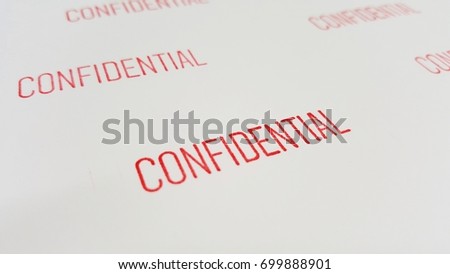 Close up of many red confidential text on white paper background.