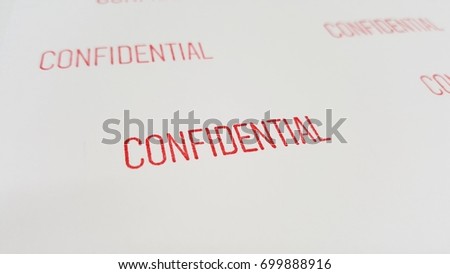 Close up of many red confidential text on white paper background.
