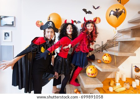 Children riding on a broomstick on a Halloween holiday