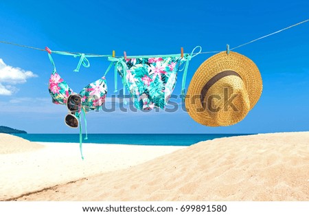 Fashion summer swimsuit bikini, sunglasses and big hat on rope. Summer bikini and accessories stylish outfit beach set. Ocean sea vacation.  Summer Concept