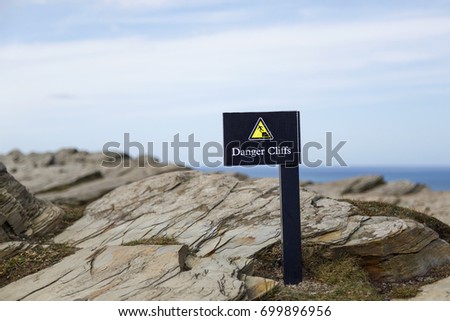 Danger sign on a cliff 