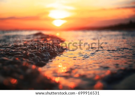 Waves on the beach in the tropics at sunset
