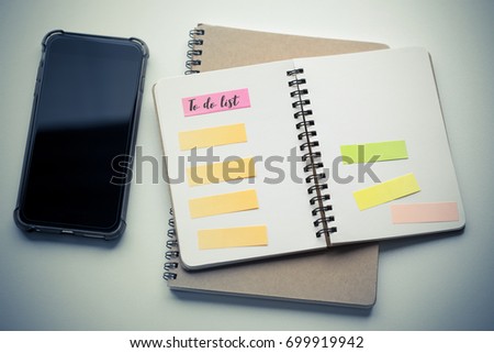 To do list on notebook and mobile phone with vintage color effected