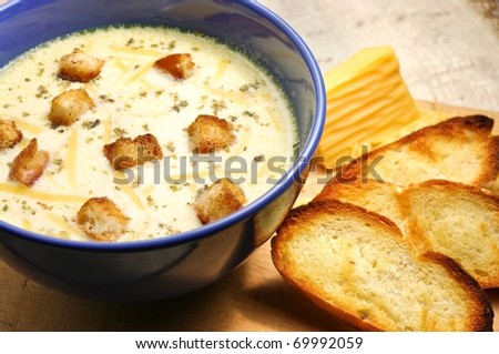 Cheese soup with toasts in blue pottery Royalty-Free Stock Photo #69992059