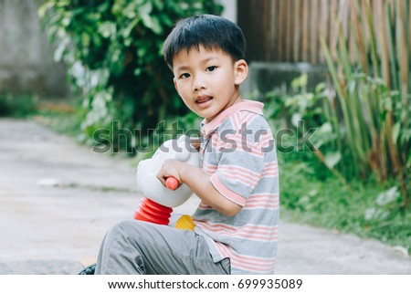 little Asian boy smile and rid a bike