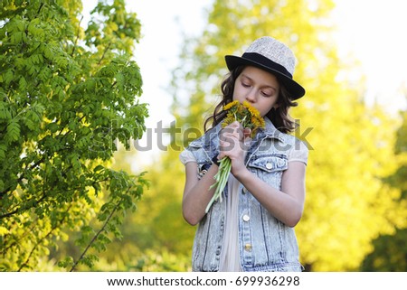 Girl in the park in the evening of a sunny day in the spring
