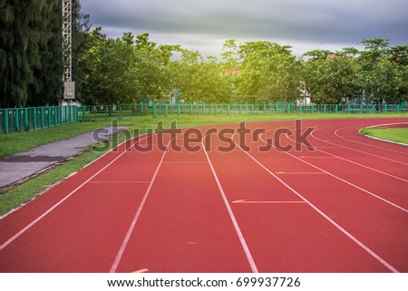 Red running track in stadium,running track on blue sky in the morning