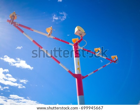 Aviation light signals at the runway landing zone of Airport isolated on blue sky background.