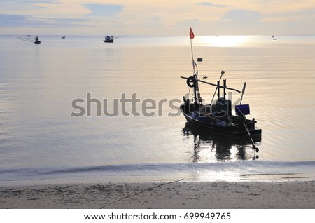 Fisher boat on sunset at the sea