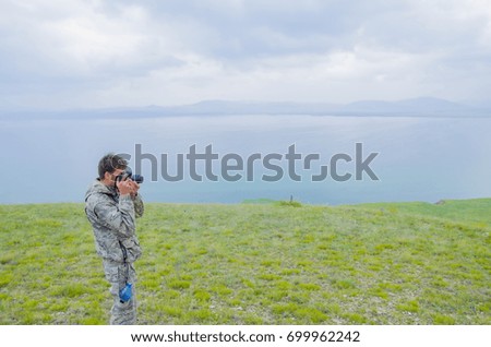 A man photographs the mountains