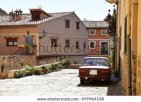 Old car with landscape of village houses on a sunny day in Guadalajara, Spain