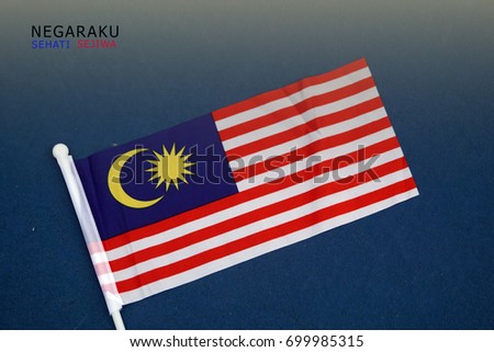 Malaysian flags with words " NEGARAKU SEHATI SEJIWA" which means my nations, one heart in english. Royalty-Free Stock Photo #699985315
